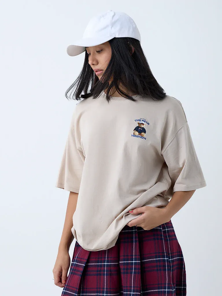 Beige Oversized Graphic T-Shirt for Women – “The Real Minimum” Teddy Print